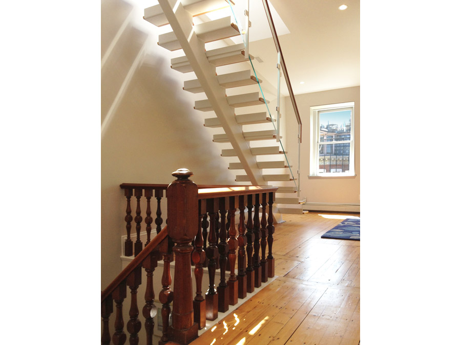 Sunlight through the stairs of the South End rowhouse.