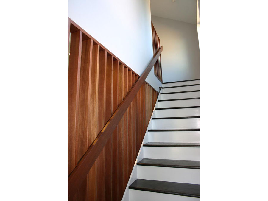 Stairs with a simple railing in the Somerville home renovation.