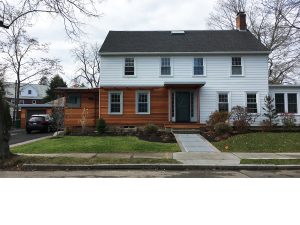 Natural wood finish siding on Boston green home design.